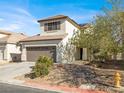 Two-story home with brown garage door and landscaping at 5120 First Sun St, North Las Vegas, NV 89081