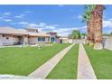 Landscaped yard with stone pathways leading to the house entrance at 7831 Rancho Destino Rd, Las Vegas, NV 89123