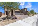 Two-story house with three-car garage and brick driveway at 246 Polaris Ridge Ave, Henderson, NV 89011