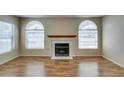 Living room with fireplace and arched windows at 7732 Almeria Ave, Las Vegas, NV 89128