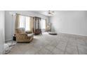 Living room with tile floor, ceiling fan, and comfortable armchair at 367 Lander Dr, Henderson, NV 89074