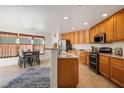 Open kitchen with ample cabinetry, stainless steel appliances, and breakfast bar at 9785 Iron Mine St, Las Vegas, NV 89183