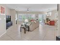 Open concept living room with tile floors, a fireplace, and views to the dining area at 2369 Wisconsin Dells Dr, Henderson, NV 89044