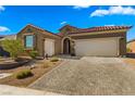 Two-story house with a brick driveway and landscaping at 977 Majestic Vw, Mesquite, NV 89034