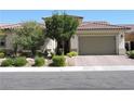 Single-story home with two-car garage and landscaping at 270 Besame Ct, Las Vegas, NV 89138