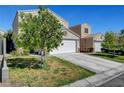 Two-story house with a white garage door and landscaping at 3264 Sutters Fort St, North Las Vegas, NV 89032