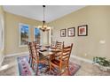 Formal dining room with a wood table and six chairs, and a tile floor at 536 E Fairway Rd, Henderson, NV 89015