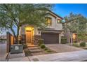 Two-story house with a brown garage door and stone accents at 2232 Mundare Dr, Henderson, NV 89002