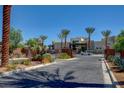 Gated community entrance with palm trees and paved driveway at 11270 Hidden Peak Ave # 201, Las Vegas, NV 89135