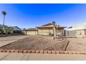 House exterior featuring a large yard and driveway at 4474 El Carnal Way, Las Vegas, NV 89121