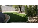 Artificial turf backyard with rock border at 3418 Cinnamon Creek Ave, North Las Vegas, NV 89031