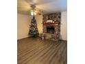 Living room featuring a stone fireplace and wood-look flooring at 4214 E Baltimore Ave, Las Vegas, NV 89104