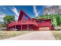 Red A-frame log cabin home with a large deck at 408 Crestview Dr, Las Vegas, NV 89124