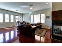 Spacious living room with hardwood floors, fireplace, and ample natural light at 9209 Tudor Park Pl, Las Vegas, NV 89145