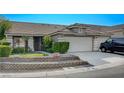 Home's exterior with two-car garage and landscaping at 3512 Jewel Night St, Las Vegas, NV 89129