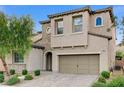 Tan two-story house with a two-car garage and landscaping at 201 White Mule Ave, Las Vegas, NV 89148