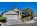 Two-story house with a white garage door and driveway at 8104 Bay Springs Dr, Las Vegas, NV 89128