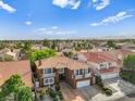 Aerial view of two story house with tile roof, fountain, and landscaped yard at 8309 Aqua Spray Ave, Las Vegas, NV 89128