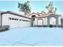 Two-story house with tile roof and attached three-car garage at 171 Jeri Dr, Henderson, NV 89074