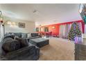 Living room features a sectional sofa, large TV, and Christmas tree at 2240 Horse Creek Cir, Henderson, NV 89014