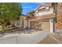 Two-story house with a curved driveway and landscaping at 5891 Prairie Ridge Cir, North Las Vegas, NV 89031