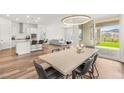 Open concept dining area with light wood table and chairs at 91 Reflection Cove Dr, Henderson, NV 89011