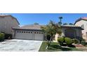 Single-story house with a three-car garage and landscaped front yard at 3021 Parchment Ct, Las Vegas, NV 89117