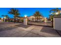 Custom gated entrance with decorative ironwork and lighting at 2780 El Camino Rd, Las Vegas, NV 89146