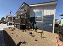 Single-wide manufactured home with a covered porch and desert landscaping at 380 Hilton Head St, Pahrump, NV 89048