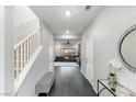 Bright entryway with bench, dark flooring, and view to living room at 10428 Rose Palisade St, Las Vegas, NV 89141