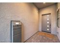 Modern entryway with gray door and a smart package receiver at 10736 Patina Hills Ct, Las Vegas, NV 89135