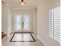 Elegant entryway with tile flooring and double doors at 1115 Aldenwood Ave, Las Vegas, NV 89123