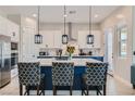 Modern kitchen with white and blue cabinets, large island, and stainless steel appliances at 7369 Rosenberger St, Las Vegas, NV 89166