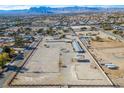 Aerial view of property showcasing stables, arena, and mountain views at 5820 W La Madre Way, Las Vegas, NV 89130