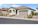 Single story home with attached garage and landscaped yard at 9518 Barnsley Point St, Las Vegas, NV 89178