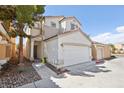 Two-story house with attached garage and landscaping at 4805 Principle Ct, North Las Vegas, NV 89031