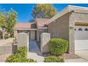 Tan one-story house with tile roof and attached garage at 8628 Desert Holly Dr # 0, Las Vegas, NV 89134