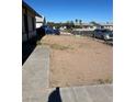 Large backyard with dirt and wooden fence at 937 Palmetto St, Henderson, NV 89015