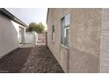 Gravel side yard with a small gate at 3423 Chedworth Rd, North Las Vegas, NV 89031