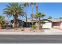 Single story home with landscaped yard and palm trees at 2407 Bonita Ln, Henderson, NV 89014