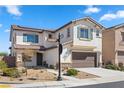 Two-story house with brown garage door, solar panels, and landscaping at 876 Punto Di Bellezza, Henderson, NV 89011