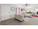 Living room features beige sofas, wood-look flooring, and a dining area at 2761 Hacienda St, Pahrump, NV 89048