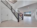 Open concept entryway with modern staircase and tile flooring at 6914 Pacific Robin St, North Las Vegas, NV 89084