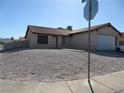 Single story home with a two-car garage and gravel landscaping at , Henderson, NV 89015