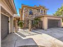 Home exterior showcasing stone accents, iron gate, and attached garage at 11 Canoa Hills Dr, Henderson, NV 89052