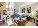 Spacious living room featuring a large sectional sofa and ornate coffee table at 2619 White Pine Dr, Henderson, NV 89074