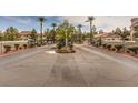 Gated community entrance with palm trees and landscaping at 601 Devonhall St # 202, Las Vegas, NV 89145