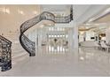 Grand foyer with a curved staircase and high ceilings at 1721 S Tioga Way, Las Vegas, NV 89117