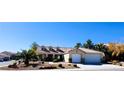 One-story house with tile roof, two-car garage, and desert landscaping at 817 Cornerstone Pl, North Las Vegas, NV 89031