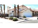 Two-story house with tile roof and attached garage at 3275 Canyon Terrace Dr, Laughlin, NV 89029